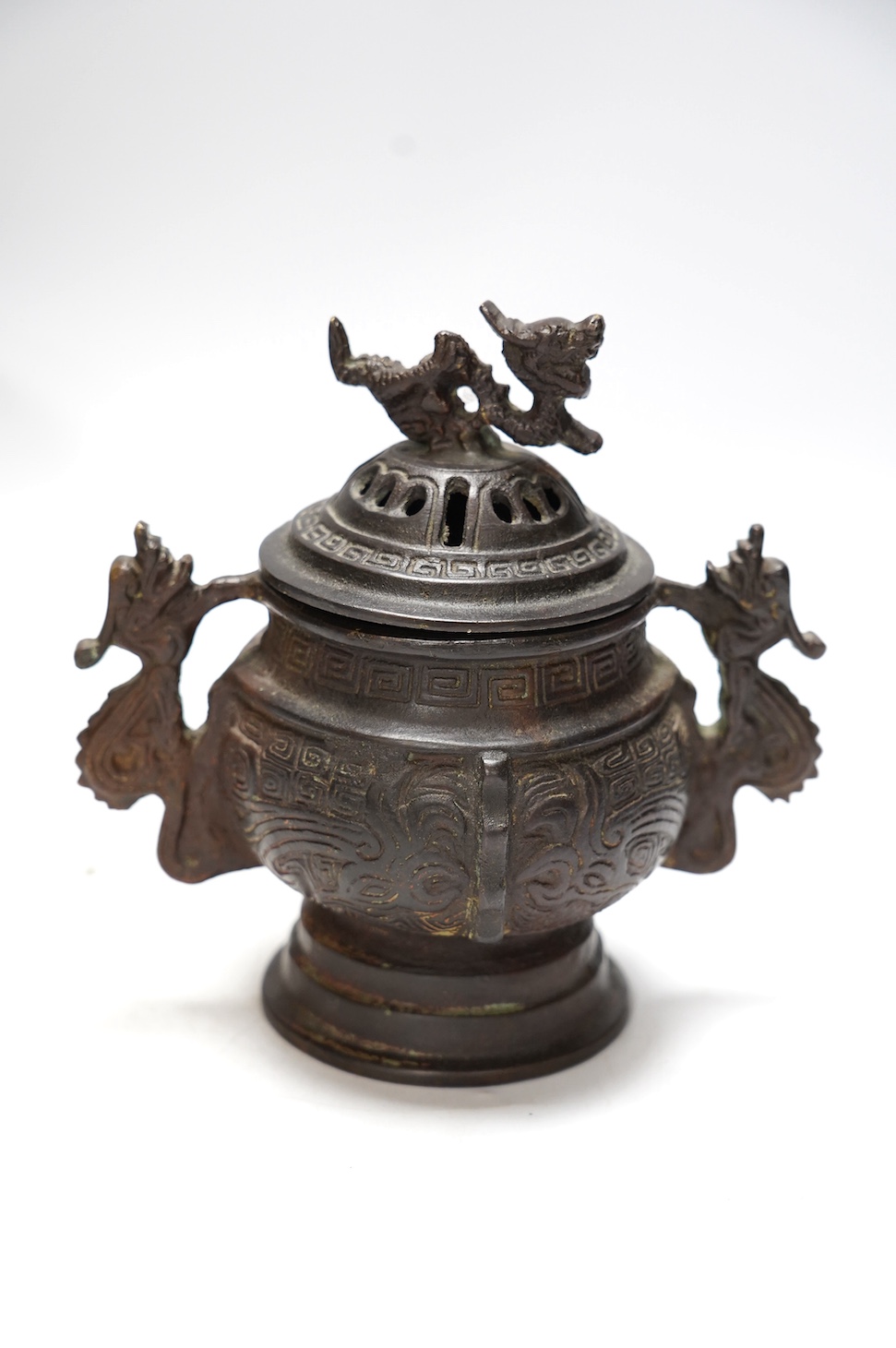 A Chinese bronze censer and cover, a Chinese bronze bowl and an Indian bronze seated deity, tallest 19cm high. Condition - fair some general scuffs and wear, the figure has a chip